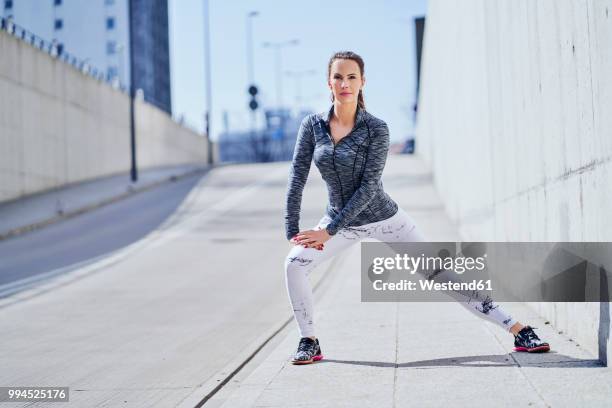 female runner stretching legs during urban workout - one katowice 2018 bildbanksfoton och bilder