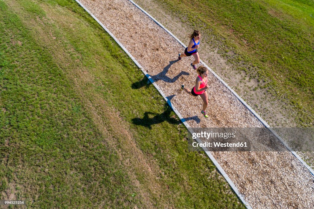 Aerial view of female joggers on woodchip trail
