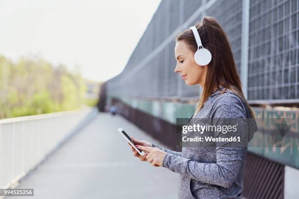 woman with headphones using smartphone - one katowice 2018 bildbanksfoton och bilder