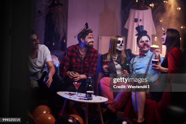 group of friends celebrating halloween - adult halloween party stockfoto's en -beelden