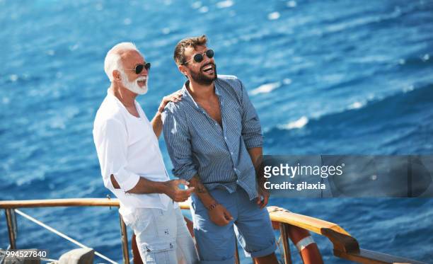 father and son sailing. - gilaxia stock pictures, royalty-free photos & images