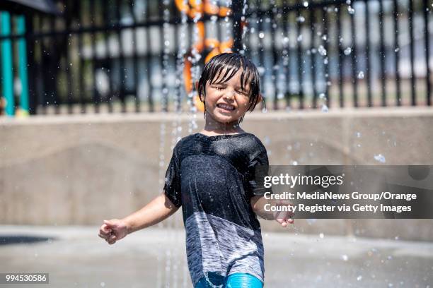 Child cools off in the splash pad at Pioneer Park in Anaheim, CA on Friday, July 6, 2018. Families were trying to escape the 100-plus degree...