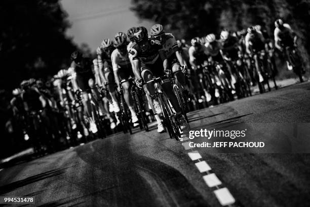 The pack rides during the second stage of the 105th edition of the Tour de France cycling race between Mouilleron-Saint-Germain and La Roche-sur-Yon,...