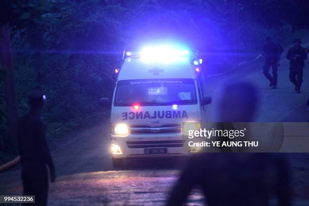 An ambulance exits from the Tham Luang cave area as rescue operations continue for those still trapped inside the cave in Khun Nam Nang Non Forest...