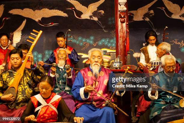 Elderly and young musicians in a Naxi Orchestra, a Naxi minority group playing at the Naxi Music Academy, Naxi Guyue Hui, in Old Town Lijiang, Yunnan...