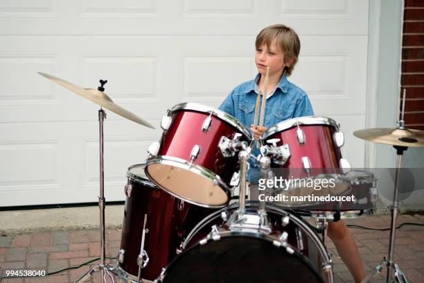 young drummer rehearsing before show in family driveway. - "martine doucet" or martinedoucet stock pictures, royalty-free photos & images