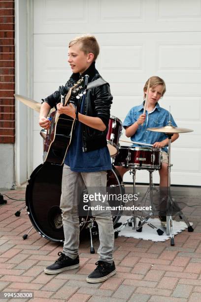 boy's band in concert in family driveway in summer. - "martine doucet" or martinedoucet stock pictures, royalty-free photos & images