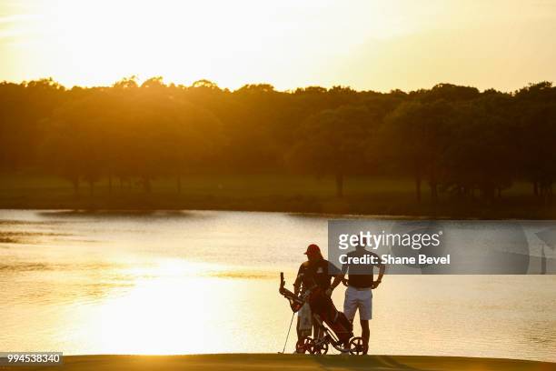 Haley Moore of Arizona speaks with associate head coach Derek Radley on the 18th green during the Division I Women's Golf Team Match Play...