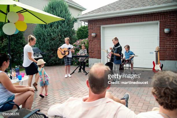boy's band in concert in family driveway in summer. - "martine doucet" or martinedoucet stock pictures, royalty-free photos & images