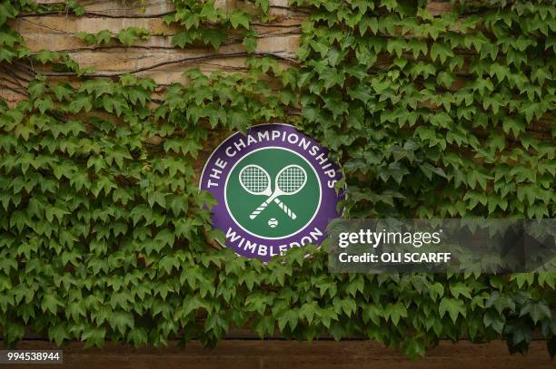 The Wimbledon logo is surrounded by ivy on the seventh day of the 2018 Wimbledon Championships at The All England Lawn Tennis Club in Wimbledon,...