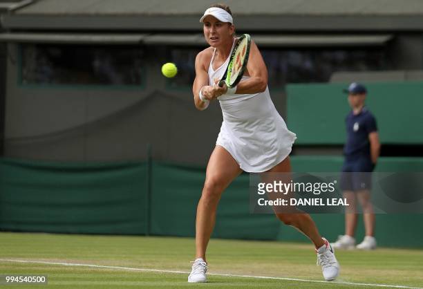 Switzerland's Belinda Bencic returns against Germany's Angelique Kerber during their women's singles fourth round match on the seventh day of the...