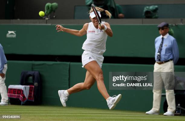 Germany's Angelique Kerber returns against Switzerland's Belinda Bencic during their women's singles fourth round match on the seventh day of the...