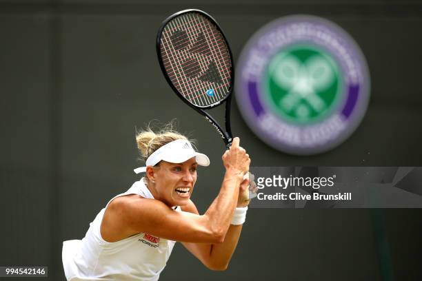Angelique Kerber of Germany plays a backhand against Belinda Bencic of Switzerland during their Ladies' Singles fourth round match on day seven of...