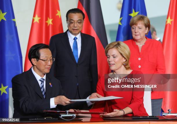 German minister for Food and Agriculture Julia Kloeckner and China's vice state minister for Agriculture Han Changfu exchange documents under the...