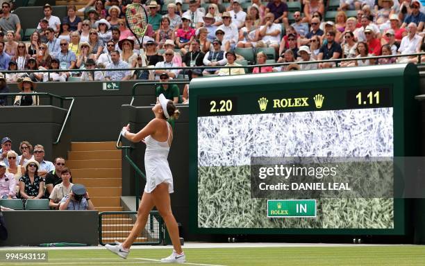 Switzerland's Belinda Bencic throws her racket in the air as she reacts to a point review against Germany's Angelique Kerber during their women's...