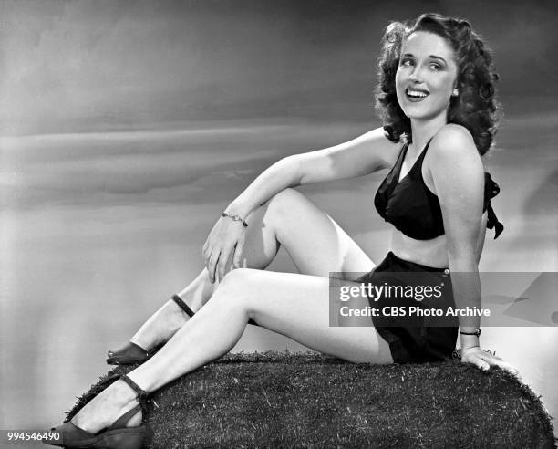 Telephone operator Gloria Holliday models a bathing suit. In December 1944, she auditions and wins the role of Garry Moores girlfriend on the...