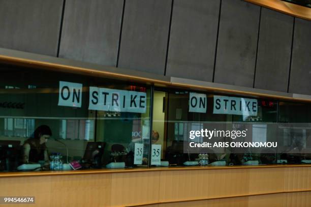 Interpreters at the European Parliament stick "On strike" banners on the windows of the their booths after 35 days of strike before the arrival of...