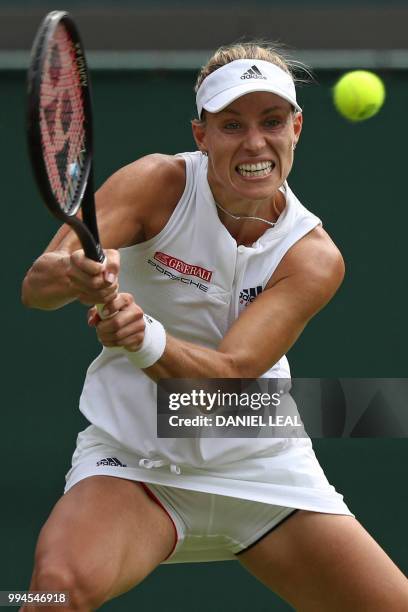 Germany's Angelique Kerber returns against Switzerland's Belinda Bencic during their women's singles fourth round match on the seventh day of the...