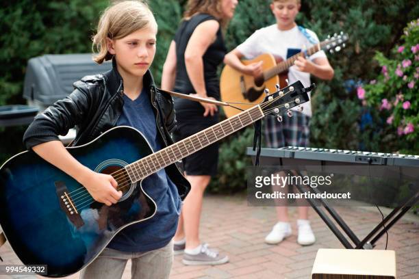 boy's band getting ready to play in family driveway. - "martine doucet" or martinedoucet stock pictures, royalty-free photos & images
