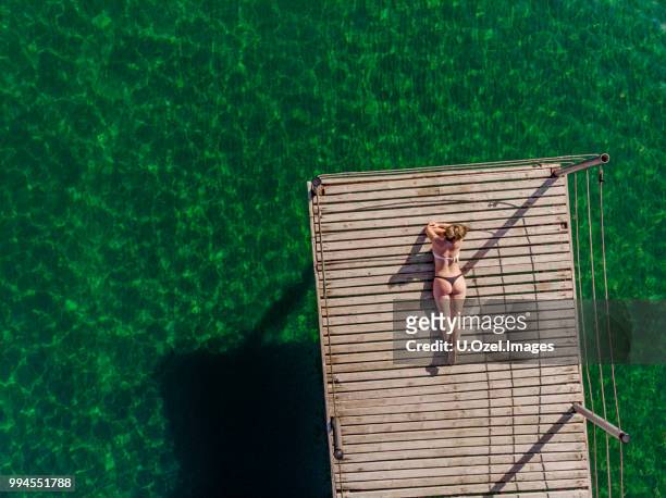 young woman relaxing at the sea - aerial beach people stock pictures, royalty-free photos & images