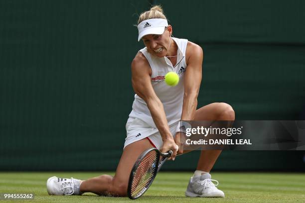 Germany's Angelique Kerber returns against Switzerland's Belinda Bencic during their women's singles fourth round match on the seventh day of the...