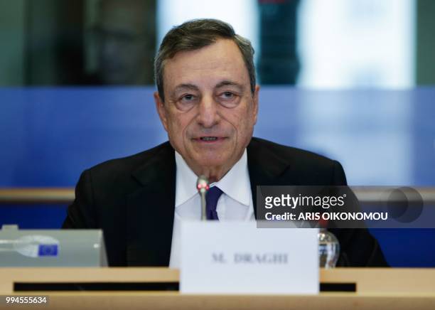 European Central Bank President Mario Draghi arrives to deliver a speech during a meeting of the Committee on economic and monetary affairs at the...