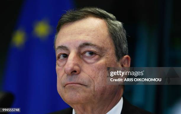 European Central Bank President Mario Draghi arrives to deliver a speech during a meeting of the Committee on economic and monetary affairs at the...