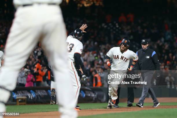 Brandon Crawford of the San Francisco Giants rounds the bases after hitting a walk-off home run in the ninth inning to defeat the Colorado Rockies...