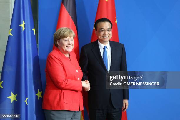 German Chancellor Angela Merkel shakes hands with Chinese Premier Li Keqiang after a joint press conference at the Chancellery in Berlin on July 9,...