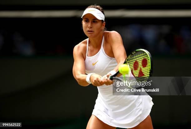Belinda Bencic of Switzerland plays a backhand against Angelique Kerber of Germany during their Ladies' Singles fourth round match on day seven of...
