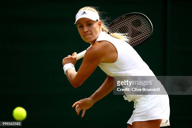 Angelique Kerber of Germany plays a backhand against Belinda Bencic of Switzerland during their Ladies' Singles fourth round match on day seven of...