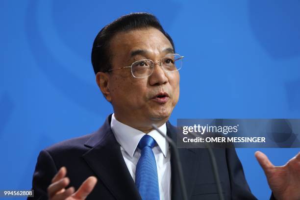 Chinese Premier Li Keqiang gestures as he speaks during a joint press conference with German Chancellor at the Chancellery in Berlin on July 9, 2018....