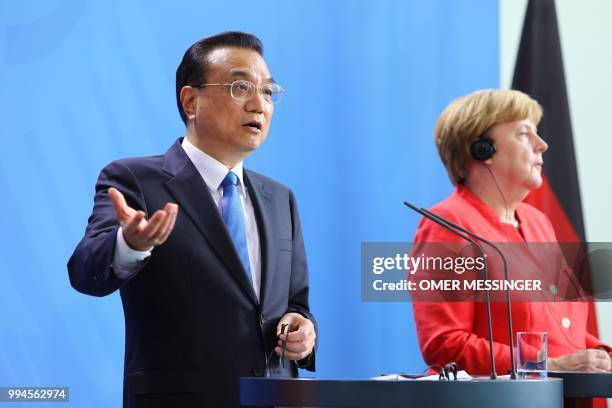 German Chancellor Angela Merkel and Chinese Premier Li Keqiang attend a press conference at the Chancellery in Berlin on July 9, 2018. - German...