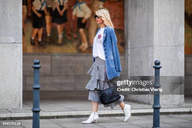 Gitta Banko wearing a denim-tweed blazer by Air Field, white t-shirt with hand painted Chanel brooch motive by Wodka Ogurez, grey checked asymmetric...