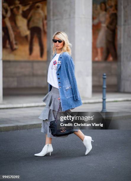 Gitta Banko wearing a denim-tweed blazer by Air Field, white t-shirt with hand painted Chanel brooch motive by Wodka Ogurez, grey checked asymmetric...