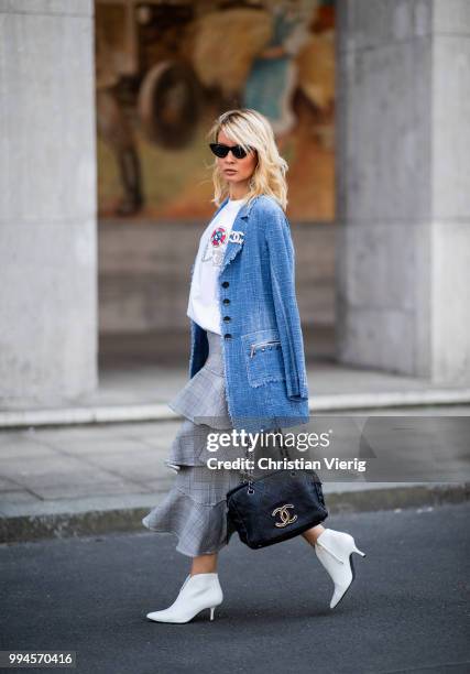 Gitta Banko wearing a denim-tweed blazer by Air Field, white t-shirt with hand painted Chanel brooch motive by Wodka Ogurez, grey checked asymmetric...