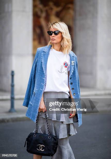 Gitta Banko wearing a denim-tweed blazer by Air Field, white t-shirt with hand painted Chanel brooch motive by Wodka Ogurez, grey checked asymmetric...