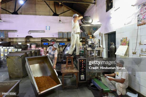Prisoners working on the packing of roasted nuts in the bakery unit inside Jail Number 2 in Tihar Jail on June 21, 2018 in New Delhi, India. The...