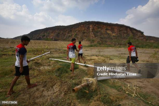 Members of M2M football club post their practice session at Ghamroj Village on June 27, 2018 near Gurugram, India. Once a cricket crazy village near...