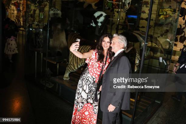 Catherine Zeta-Jones and Michael Douglas take a selfie the PEN Literary Gala at the American Museum of Natural History on May 22, 2018 in New York,...
