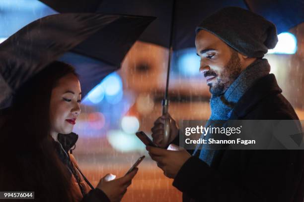 street portrait of young couples on a rainy day - stupid stock pictures, royalty-free photos & images