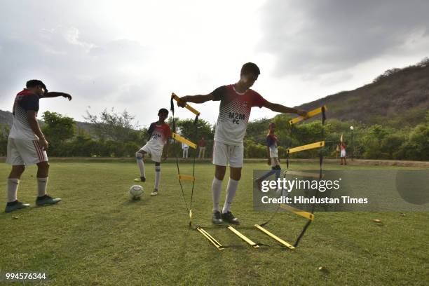 Members of M2M football club practice in a park at Ghamroj Village on June 27, 2018 near Gurugram, India. Once a cricket crazy village near Gurugram,...