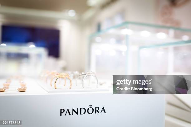 Rings and earrings sit on display in a Pandora AS store in Copenhagen, Denmark, on Monday, July 9, 2018. Pandora designs, manufactures, markets, and...