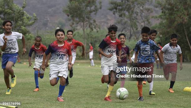 Members of M2M football club practice in a park at Ghamroj Village on June 27, 2018 near Gurugram, India. Once a cricket crazy village near Gurugram,...