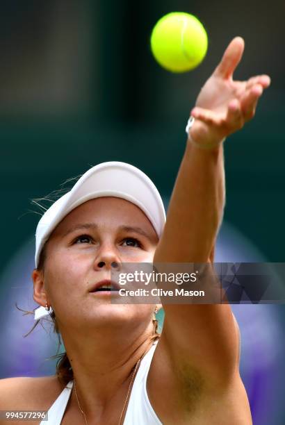 Evgeniya Rodina of Russia serves against Serena Williams of the United States during their Ladies' Singles fourth round match on day seven of the...