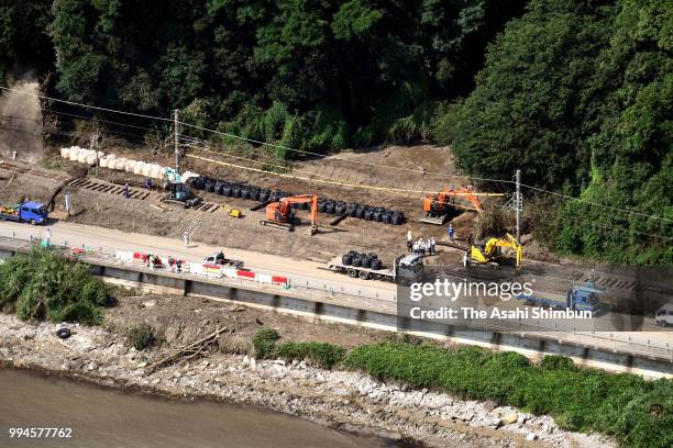 In this aerial image, restoration work continues at JR Chikuhi Line on July 9, 2018 in Karatsu, Saga, Japan. The death toll from the torrential rain...