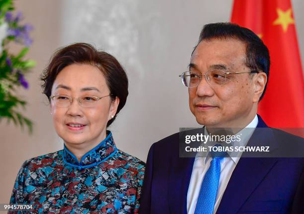 Chinese Premier Li Keqiang and his wife Cheng Hong pose as they arrive at the Bellevue presidential Palace to meet the German President and his wife...