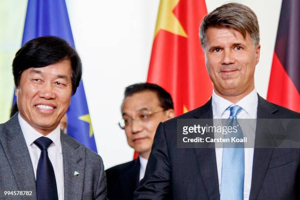 Qi Yumin, CEO of Brilliance Auto Group and Harald Krueger , CEO of German BMW shaking hands after signing a contract in the Chancellory on July 9,...