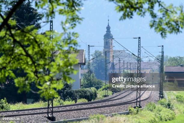 July 2018, Germany, Flintsbach Am Inn: A train of the Austrian Federal Railways driving over the tracks of the Bahntrasse through the valley of the...