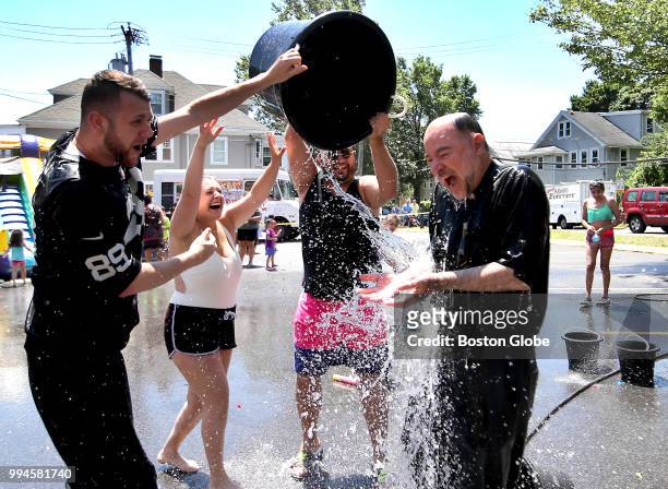 Parishioners douse Father Arakel Aljalian during their celebration of Vartavar in the parking lot of St. James Armenian Apostolic in Watertown, MA on...